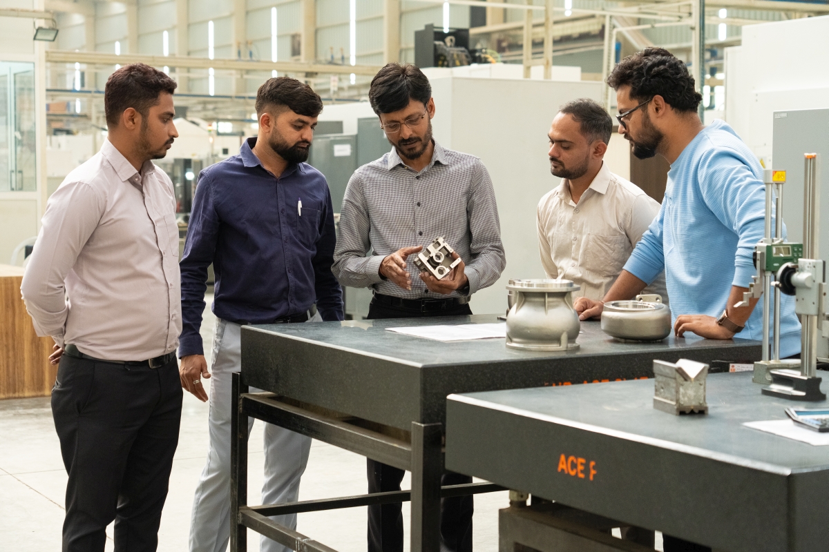 A precision-machined component is being inspected at the Shilpan Steelcast Precision Machining Facility in India.